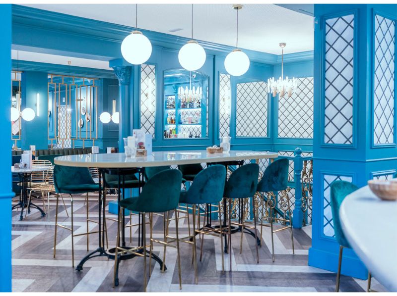 restaurant by guille garcia - hoz with blue chairs and white table